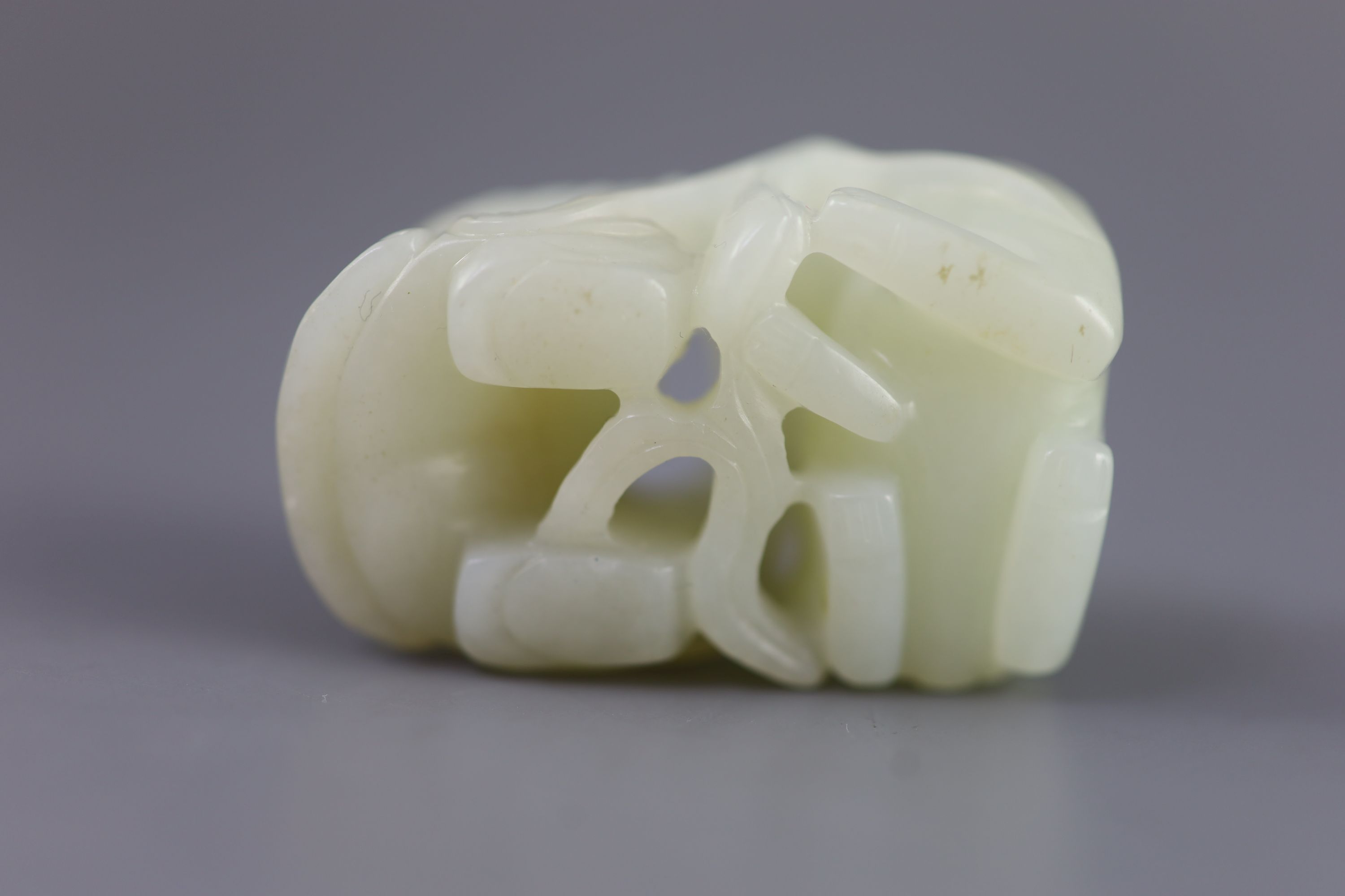 A Chinese pale celadon jade group of a boy and a lion-dog, 19th/20th century, 5.4cm